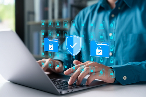 노트북을 하는 손 위로 보안을 뜻하는 자물쇠, 방패 등의 아이콘이 그려져 있다.