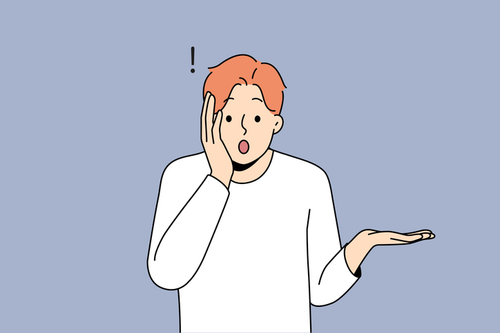 비밀유지계약서를 작성하며 한 실수에 놀란 남자가 놀란 표정으로 손을 얼굴에 대고 있다.